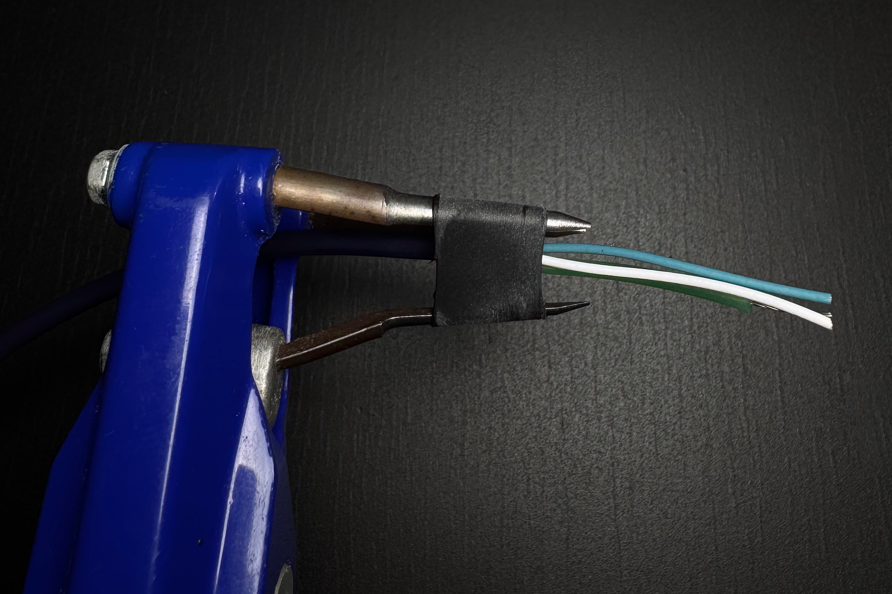 Hellerman SS tool inserting a sleeve on an audio cable.